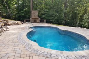 Swimming Pool with decorative outside fireplace